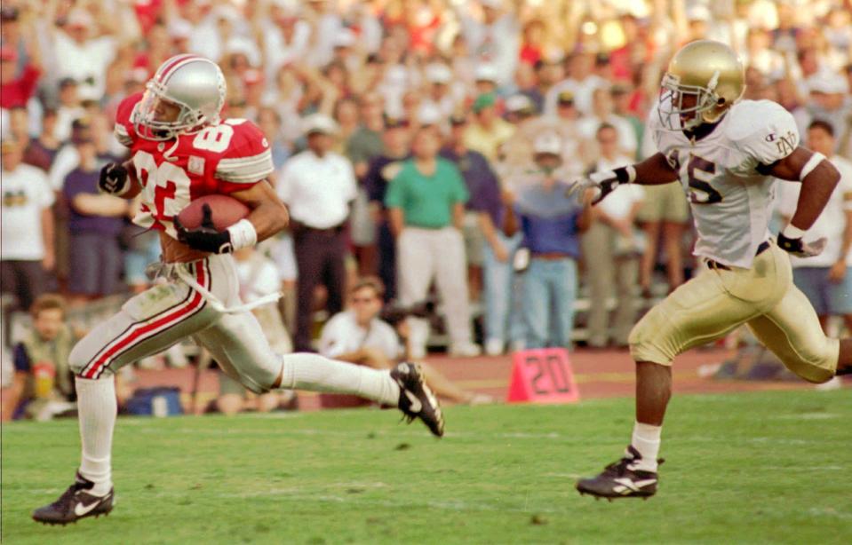 FILE--Ohio State's Terry Glenn (83) runs into the endzone for a touchdown trailed by Notre Dame defender Allen Rossum (15) in the third quarter on Sept. 30, 1995, in Columbus, Ohio. Ohio State's 1995 team bears an uncanny resemblance to Penn State's 1994 squad, and that means this year's version of the Nittany Lions may be in trouble Saturday, Oct. 7, 1995.  No. 5 Ohio State (4-0) has a quick-strike offense led by quarterback Bobby Hoying, tailback Eddie George and Glenn.  (AP Photo/Stuart Reid, file)