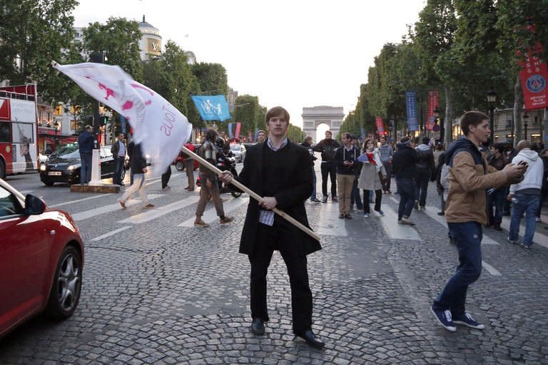 A supporter of the French anti-gay marriage movement "La Manif Pour Tous" attempts to hold an unauthorised demonstration on the Avenue des Champs-Elysees in central Paris on May 25, 2013