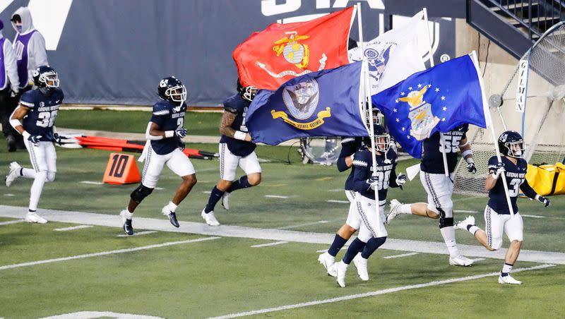 Utah State Aggies players step on the field during an NCAA football game against New Mexico Lobos at Maverik Stadium in Logan on Nov. 26, 2020.