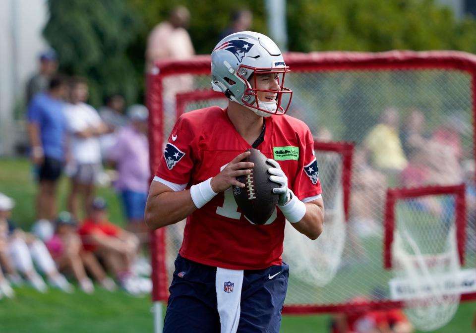 Patriots quarterback Mac Jones looks to pass during a drill at the team's practice facility in Foxboro on July 30.