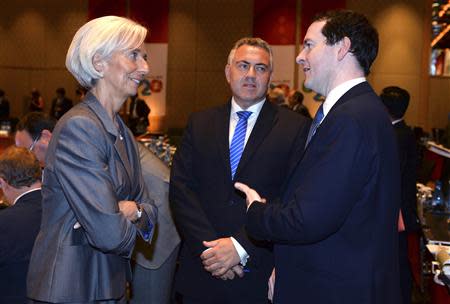 International Monetary Fund Managing Director Christine Lagarde (L) chats with Britain's Chancellor of the Exchequer George Osbourne (R) and Australia's Treasurer Joe Hockey before the G20 Finance Ministers and Central Bank Governors round table meeting in Sydney, February 22, 2014. REUTERS/William West/Pool