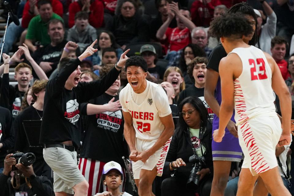 Fishers Tigers guard Jonanthony Hall (22) celebrates scoring against the Ben Davis Giants on Saturday, March 30, 2024, during the IHSAA boys basketball Class 4A state championship game at Gainbridge Fieldhouse in Indianapolis. The Fishers Tigers defeated the Ben Davis Giants 65-56.