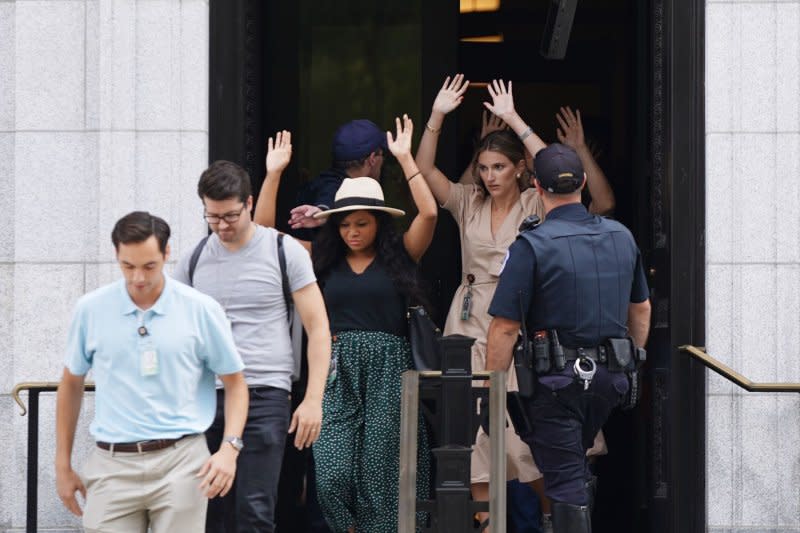 People evacuate the Russell Senate Office Building in Washington, D.C., after a report of a possible active shooter inside the building Wednesday. Officers later reopened all Senate office buildings, calling the report a "bogus call." Photo by Bonnie Cash/UPI