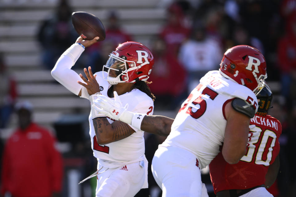 Rutgers quarterback Gavin Wimsatt (2) passes under pressure from Maryland linebacker Durell Nchami (30) during the first half of an NCAA college football game, Saturday, Nov. 26, 2022, in College Park, Md. Rutgers offensive lineman J.D. DiRenzo is at center. (AP Photo/Nick Wass)