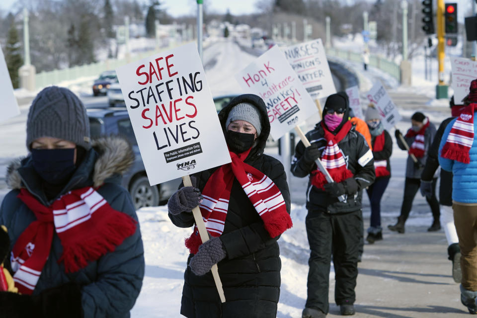 Nurses picket Friday, Feb. 12, 2021 in Faribault, Minn., during a healthcare worker protest of a shortage on protective masks. (AP Photo/Jim Mone)