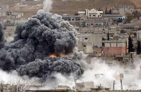 An explosion following an air strike is seen in central Kobani in Syria, November 17, 2014. REUTERS/Osman Orsal