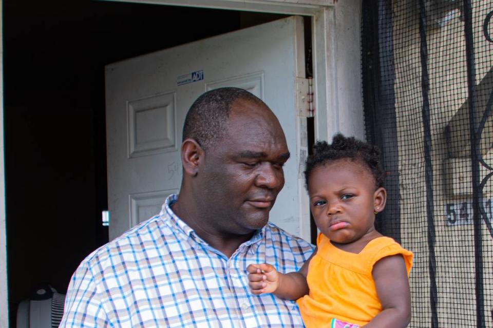 Pierre Robinson, 45, the uncle of Precious Paraison, who was killed by a 60-shot fusillade in Miami Shores early Thursday morning, June 18, 2020, holds her one-year-old daughter, Kiki Paraison.