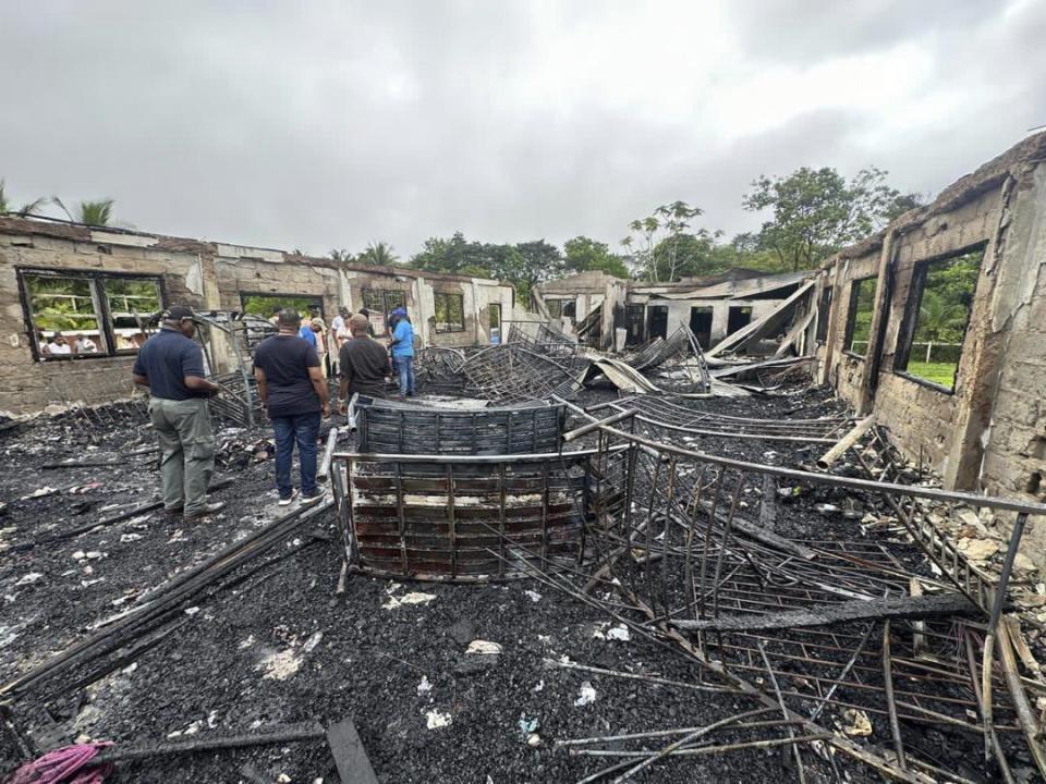 In this photo provided by Guyana's Department of Public Information, the dormitory of a secondary school is burned in Mahdia, Guyana, Monday, May 22, 2023. A nighttime fire raced through the dormitory early Monday, killing at least 19 students and injuring several others, authorities said. (Guyana's Department of Public Information via AP Photo)