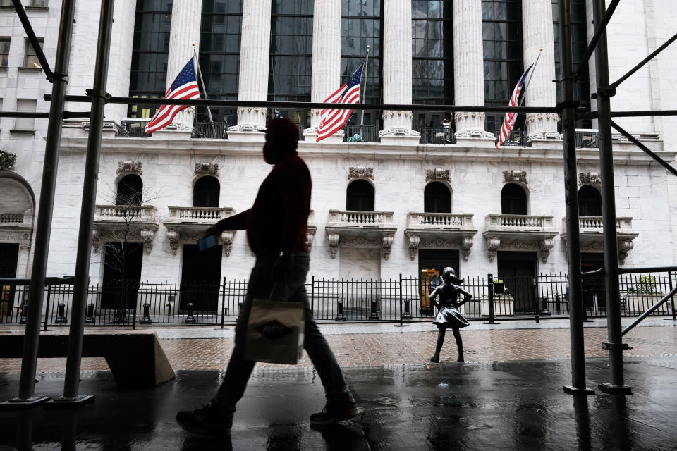 NEW YORK, NEW YORK - APRIL 15: People walk by the New York Stock Exchange on April 15, 2021 in New York City. After major companies reported strong earnings and new economic data points to a rebound in consumer spending, U.S. stocks climbed to record levels on Thursday. (Photo by Spencer Platt/Getty Images)