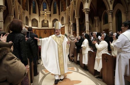 Archbishop Blase Cupich walks down the isle after his Installation Mass at Holy Name Cathedral in Chicago November 18, 2014. REUTERS/Charles Rex Arbogast/Pool