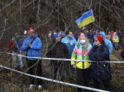 Spectators watch from the forest during the women's Biathlon World Cup 7,5 km sprint event in Nove Mesto na Morave, Czech Republic, Thursday, March 5, 2020. Due to the Corona virus the Biathlon World Cup will take place without spectators. (AP Photo/Petr David Josek)
