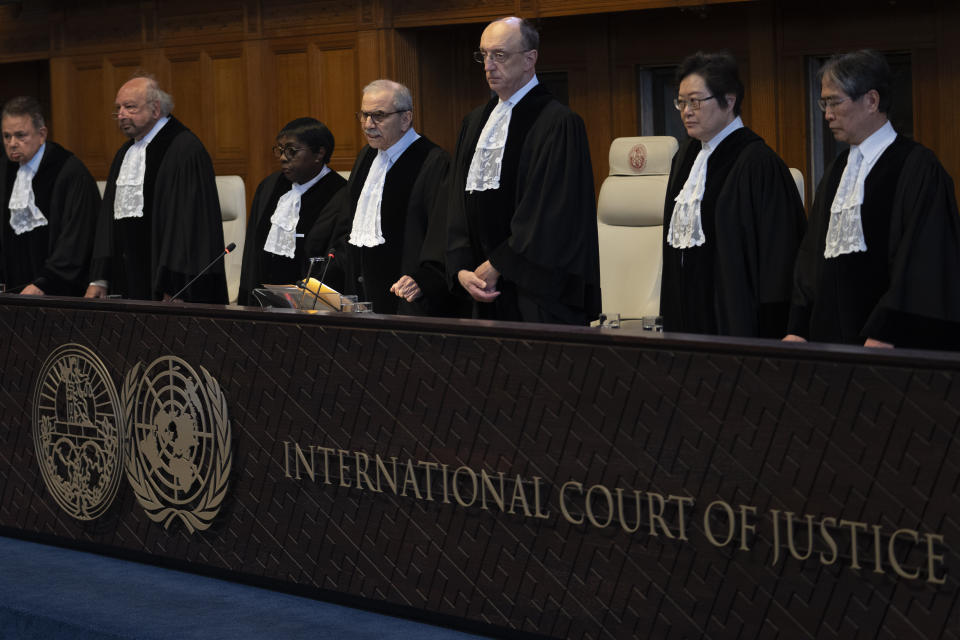 Presiding judge Nawaf Salam, fourth from left, arrives to read the ruling at the International Court of Justice in The Hague, Netherlands, Tuesday, April 30, 2024. The top U.N. court rejected on Tuesday a request by Nicaragua to order Germany to halt military and other aid to Israel and renew funding to the U.N. aid agency in Gaza. The International Court of Justice said that legal conditions for making such an order weren't met and ruled against the request in a 15-1 vote. (AP Photo/Peter Dejong)