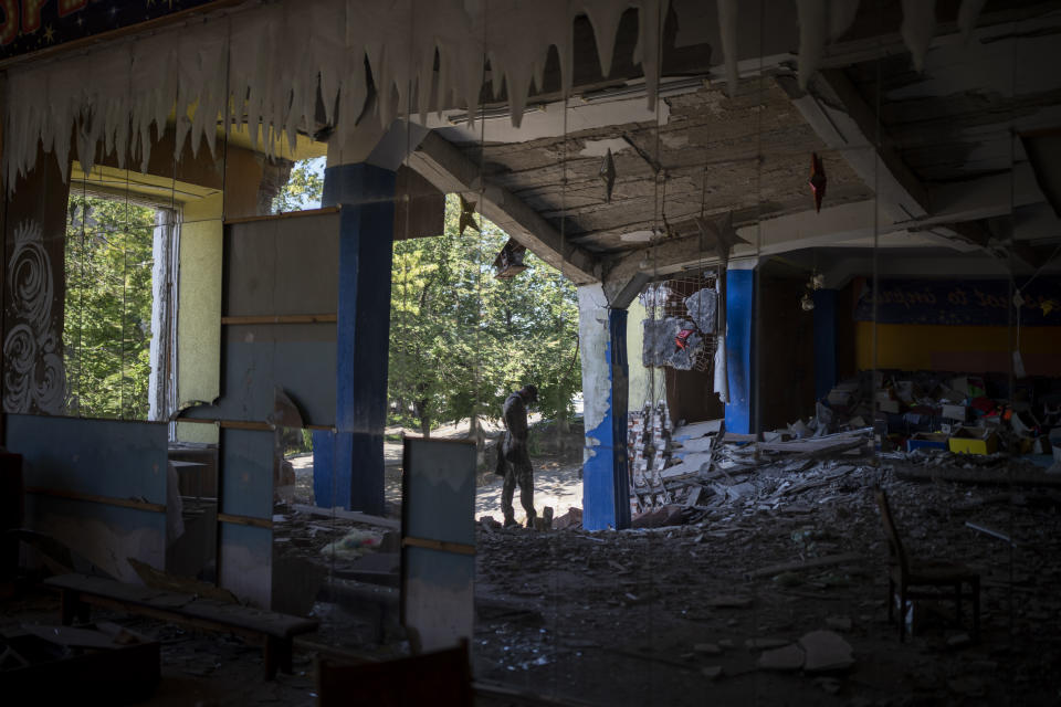 FILE - A Ukrainian soldier stands inside a dance hall that was previously bombed by Russian forces in Kupyansk, Ukraine, Monday, Aug. 14, 2023. Moscow’s army is staging a ferocious push in northeast Ukraine designed to distract Ukrainian forces from their counteroffensive and minimize the number of troops Kyiv is able to send to more important battles in the south. (AP Photo/Bram Janssen, File)