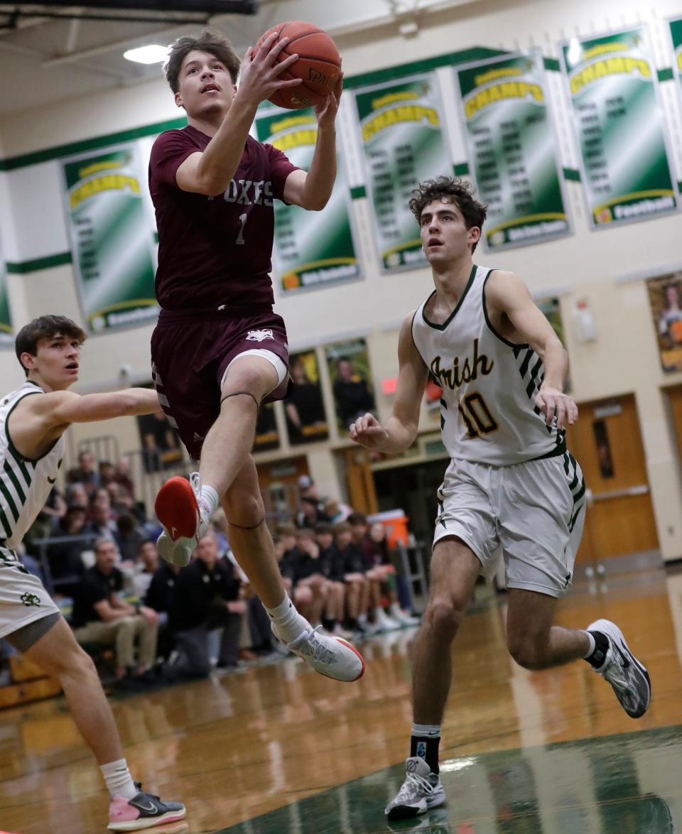 Fox Valley Lutheran's Sam Ferge drives to the basket against Freedom during their boys basketball game Tuesday in Freedom. FVL won 62-53 to clinch their third consecutive North Eastern Conference title.