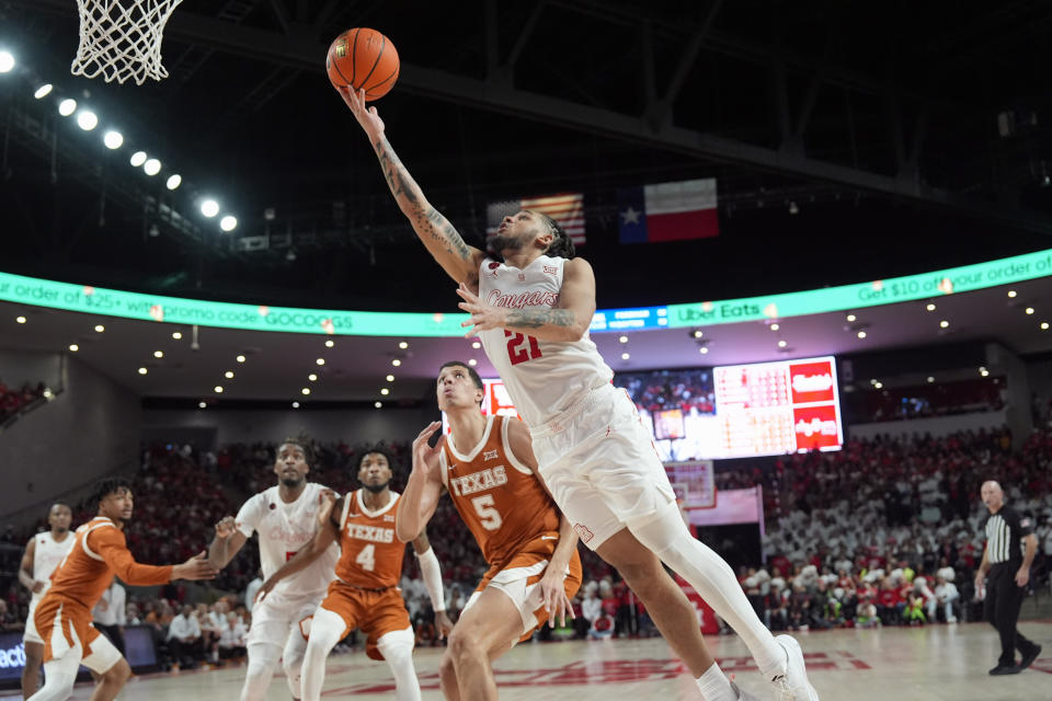 Houston's Emanuel Sharp (21) shoots as Texas' Kadin Shedrick (5) defends during the second half of an NCAA college basketball game Saturday, Feb. 17, 2024, in Houston. Houston won 82-61. (AP Photo/David J. Phillip)