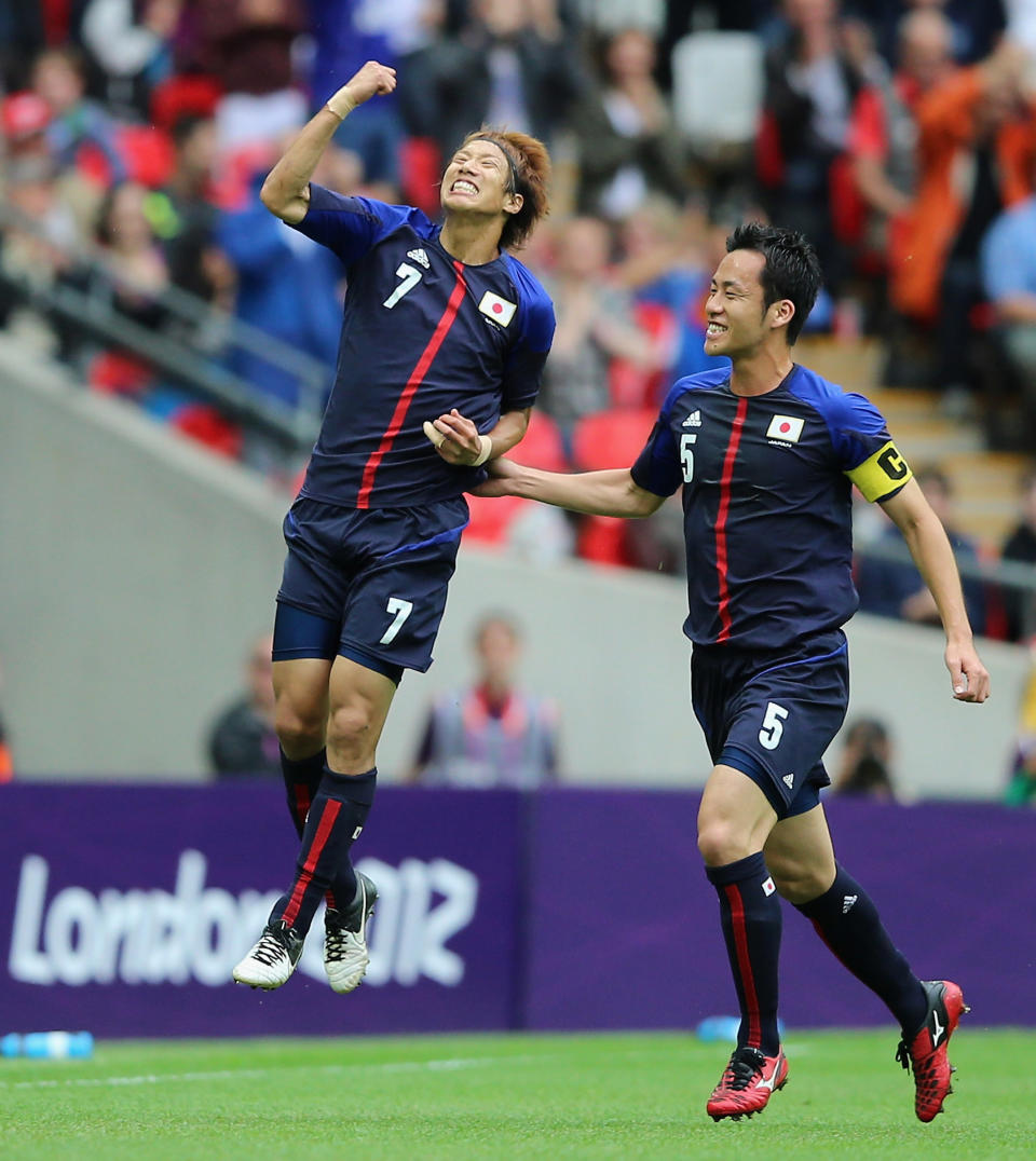 LONDON, ENGLAND - AUGUST 07: Yuki Otsu of Japan celebrates with Maya Yoshida during the Men's Football Semi Final match between Mexico and Japan, on Day 11 of the London 2012 Olympic Games at Wembley Stadium on August 7, 2012 in London, England. (Photo by Jeff J Mitchell/Getty Images)