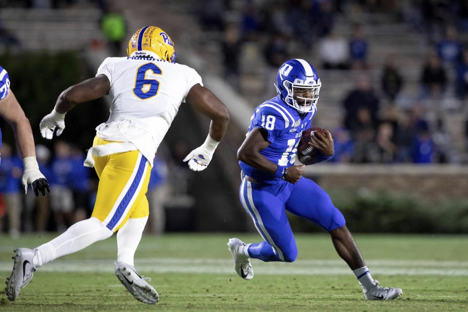 Duke's Quentin Harris (18) carries the ball as Pittsburgh's John Morgan (6) chases during an NCAA college football game in Durham, N.C., Saturday, Oct. 5, 2019. (AP Photo/Ben McKeown)