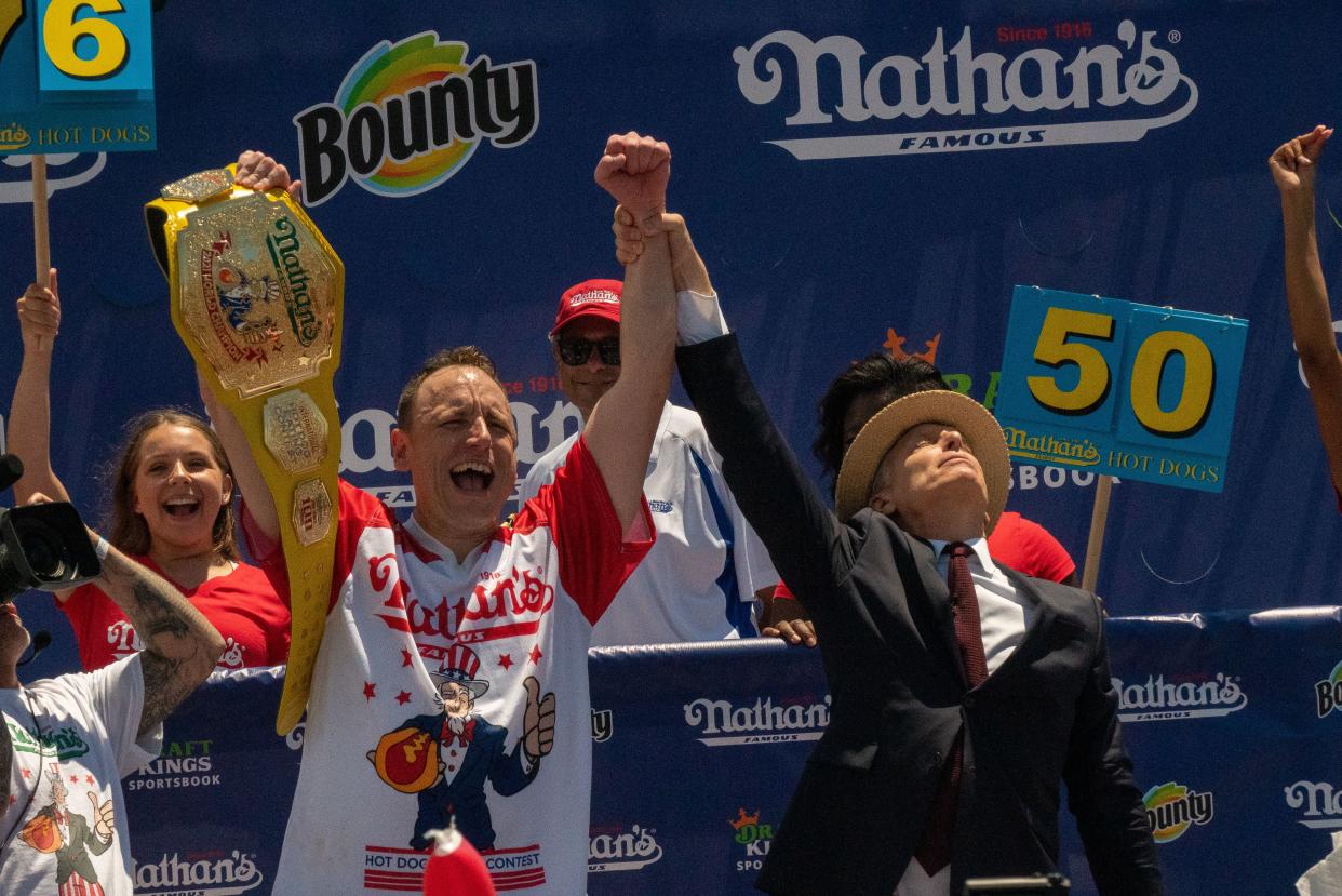 Competitive eating champion Joey "Jaws" Chestnut wins the 2021 Nathan's Famous 4th Of July International Hot Dog Eating Contest with 76 hot dogs, breaking his personal best record of 75, at Coney Island on July 4, 2021, in New York City.