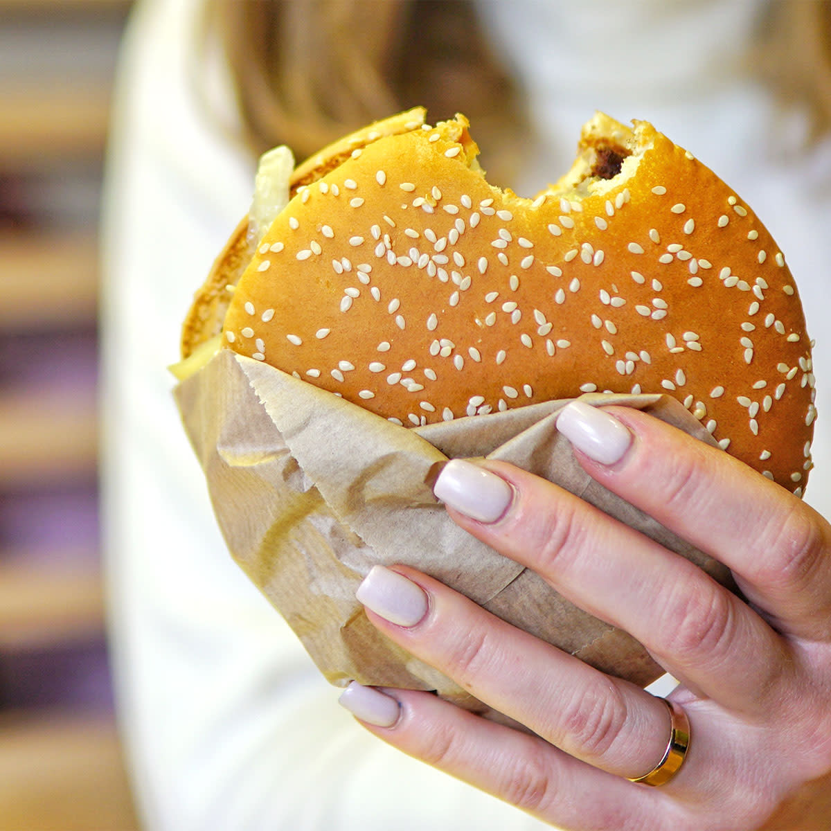 Woman biting a fast food burger