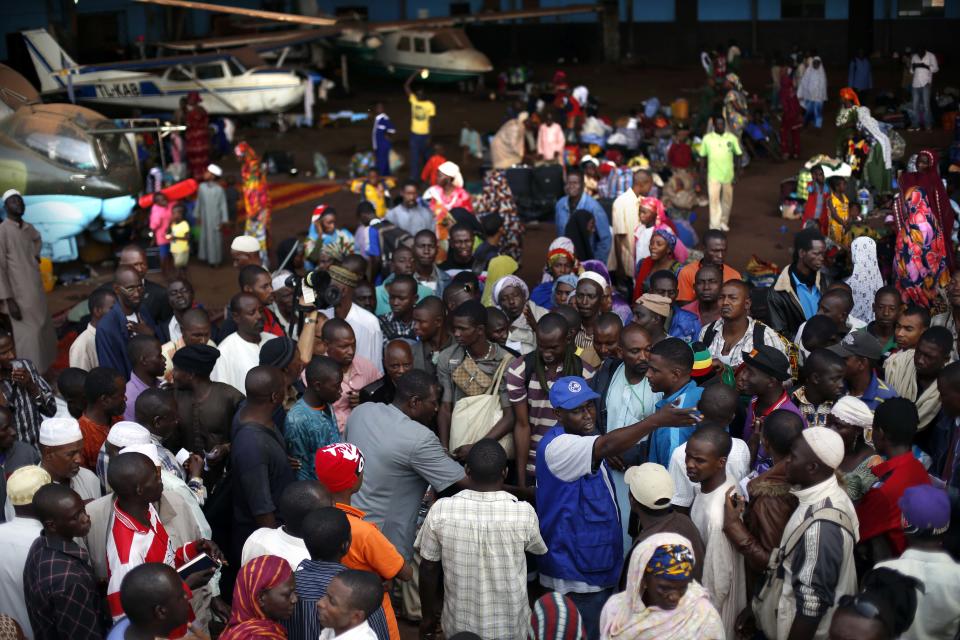 Chadian families wait for transport to Chad in a hangar at Bangui's airport in Bangui, Central African Republic, Thursday Jan. 30, 2014. Over 350 Muslim refugees were evacuated by the UN's International Organization for Migration (IOM) fleeing sectarian violence between Muslim Seleka forces and Christian anti Balaka militias. (AP Photo/Jerome Delay)