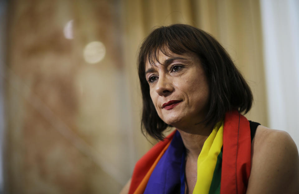 Vladimir Luxuria, a former Communist lawmaker in the Italian parliament and prominent crusader for transgender rights, sits for an interview, Monday, Feb. 17, 2014, in central Sochi, Russia, home of the 2014 Winter Olympics. Luxuria said she was detained by police at the Olympics after being stopped while carrying a rainbow flag that read in Russian: "Gay is OK." Police on Monday denied this happened. (AP Photo/David Goldman)