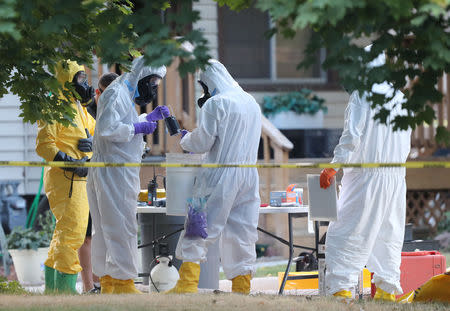 FBI and law enforcement officers in hazmat suites prepare to enter a house, which FBI says was investigating "potentially hazardous chemicals" in Logan, Utah, U.S., October 3, 2018. REUTERS/George Frey