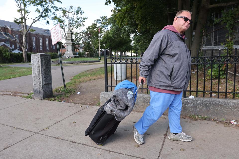 John Forest, 46, walks past Perkins Park in Brockton on Wednesday, Sept. 21, 2022. Forest was staying at the nearby Father Bill's & Mainspring shelter.