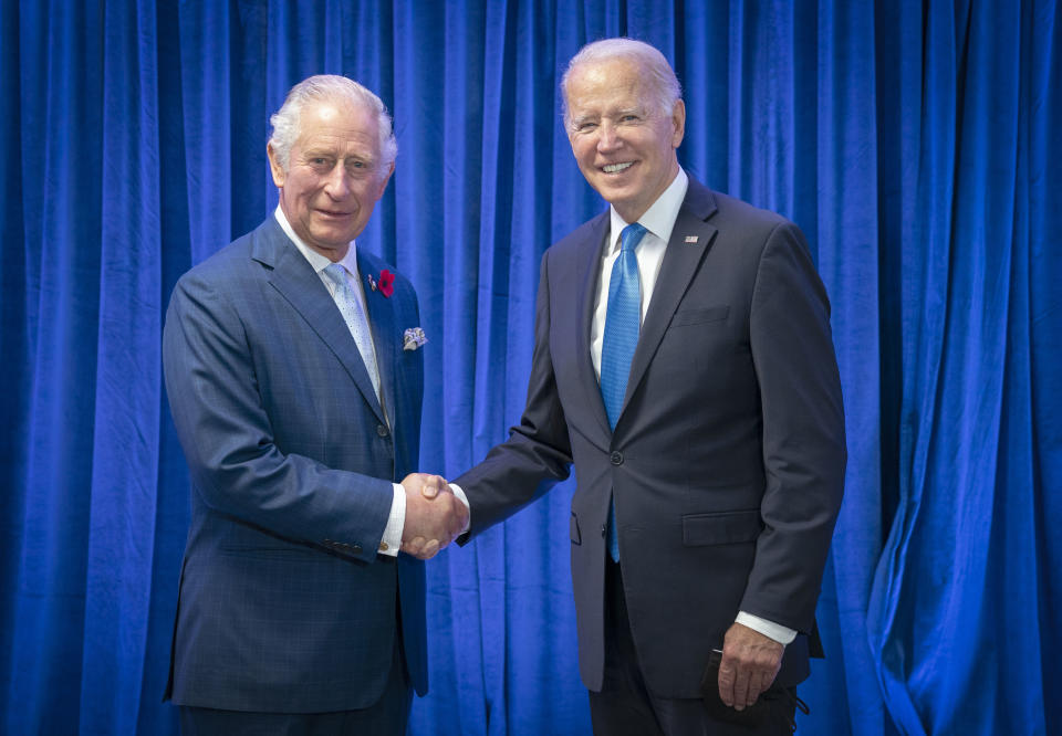 FILE - Britain's Prince Charles, left, greets the President Joe Biden ahead of their bilateral meeting during the Cop26 summit at the Scottish Event Campus (SEC) in Glasgow, Scotland, Nov. 2, 2021. (Jane Barlow/Pool Photo via AP, File)