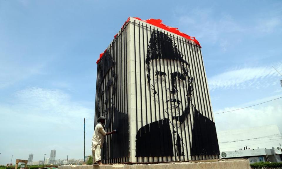 A man cleans portrait of the founder of Pakistan, Muhammad Ali Jinnah, in Karachi.