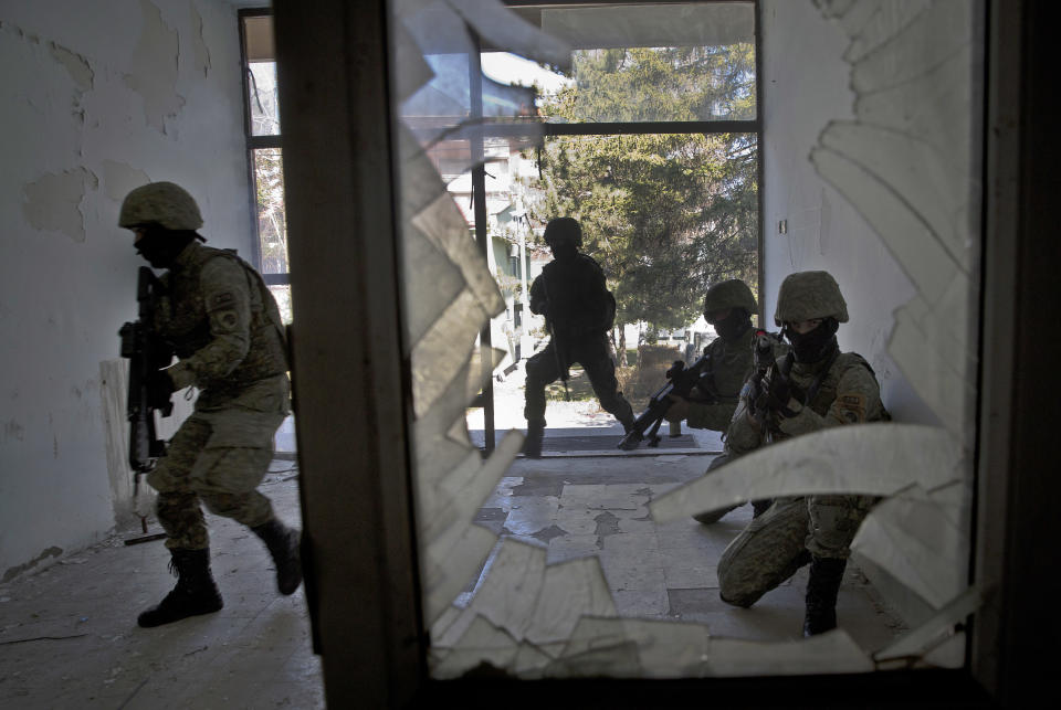 In this photo taken on Thursday, March 22, 2018, member of Kosovo Security Force (KSF) train during hostage rescue exercise inside the barracks in the southern part of the ethnically divided town of Mitrovica. In a vote set for Friday, Dec. 14, 2018, Kosovo’s 120-seat parliament is expected to approve draft government-submitted legislation to turn an existing 4,000-strong paramilitary force, known as the Kosovo Security Force, into an expanded, lightly armed army. (AP Photo/Visar Kryeziu)