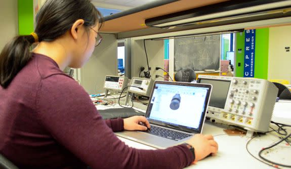 Charlene Xia, of Team Tactile, works on the technology behind the device.