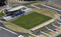 This July 27, 2018, aerial photo, shows Kamaishi Recovery Memorial Stadium in Kamaishi, northern Japan. Japan opened the new stadium Sunday, Aug. 19, 2018, for the 2019 Rugby World Cup on the site of a school that was destroyed by a devastating tsunami in 2011. The 6,000-seat stadium, the only new one built for the World Cup, stands on the former grounds of an elementary school and a junior high school. (Naohiko Hatta/Kyodo News via AP)