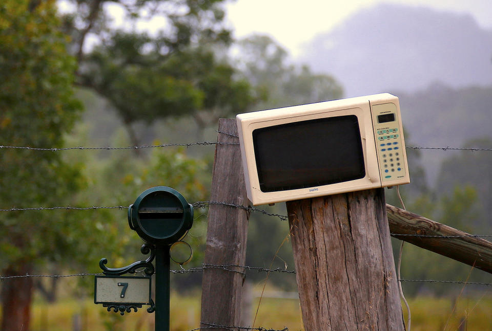 <p>An old microwave repurposed a mailbox sits next to a more traditional box in the outskirts of Wollombi township, north of Sydney, Australia. (Photo: David Gray/Reuters) </p>