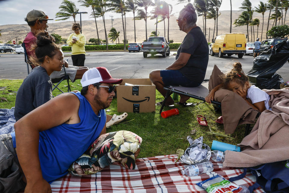 The Lopes and Vasquez family camped in a parking lot waiting to return home. / Credit: Robert Gauthier / Getty Images