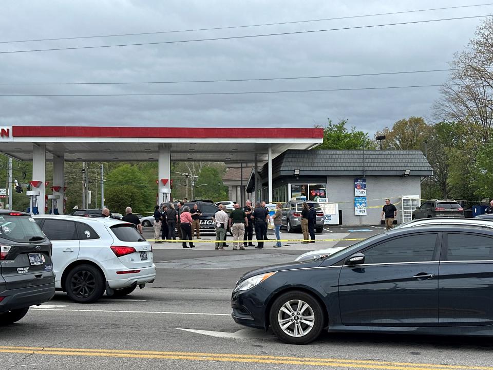 Police investigate after an officer shot a man at a gas station on Broadway.