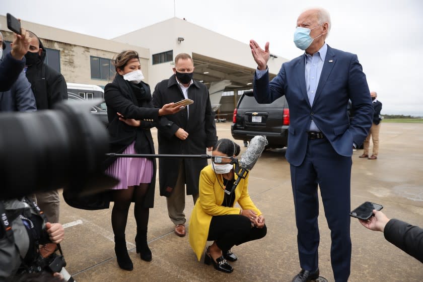 NEW CASTLE, DELAWARE - OCTOBER 12: Wearing a face mask to reduce the risk posed by the coronavirus, Democratic presidential nominee Joe Biden talks to reporters before boarding a flight to Ohio at New Castle County Airport October 12, 2020 in New Castle, Delaware. With 21 days until the election, Biden will campaign in Toledo and Cincinnati. (Photo by Chip Somodevilla/Getty Images)