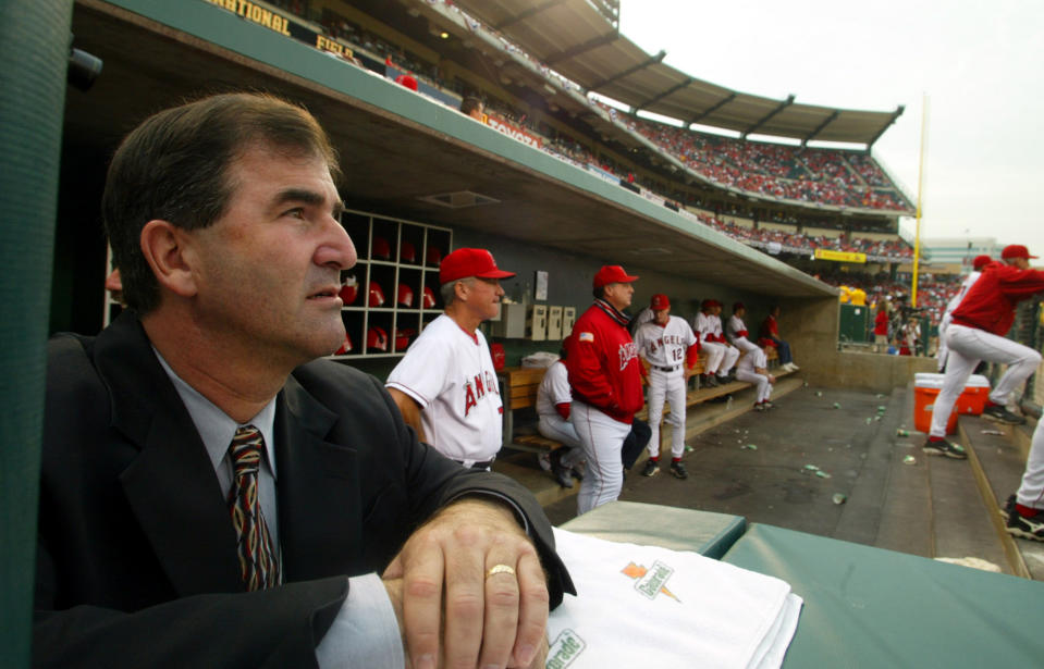 Tim Mead, left, the Anaheim Angels vice president of communications, watches the action from the dugout during game three against the the Minnesota Twins during the American League Championship Series at Edison Field, Friday Oct. 11, 2002.  (Photo by Mark Boster/Los Angeles Times via Getty Images)