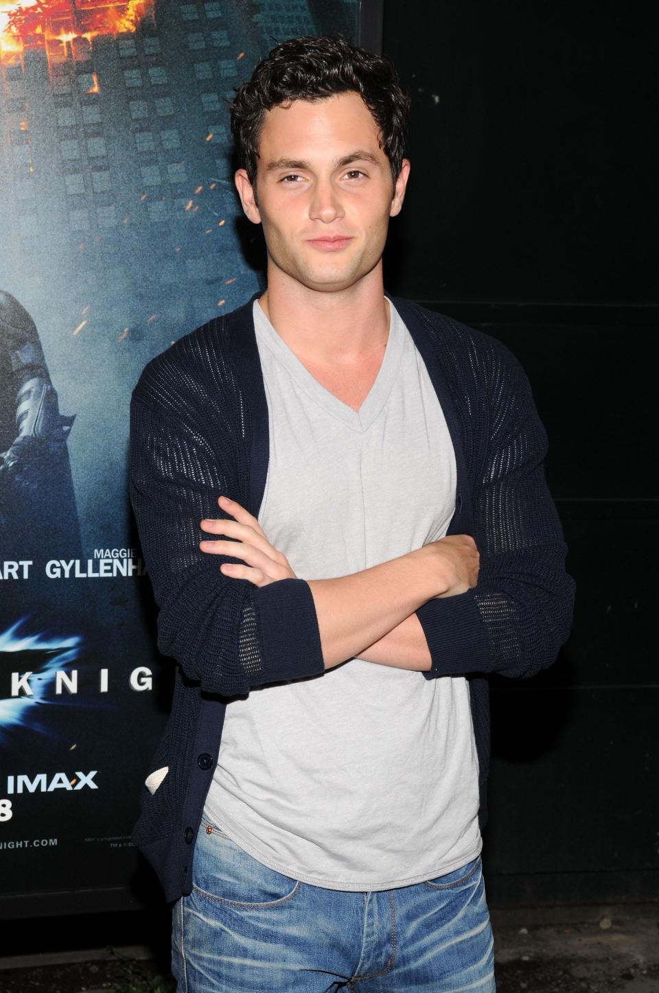 Penn Badgley with arms crossed
