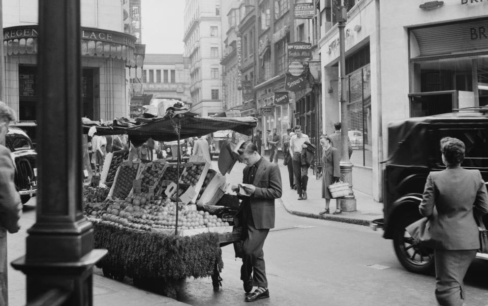 A trader outside the hotel in 1953 - Getty