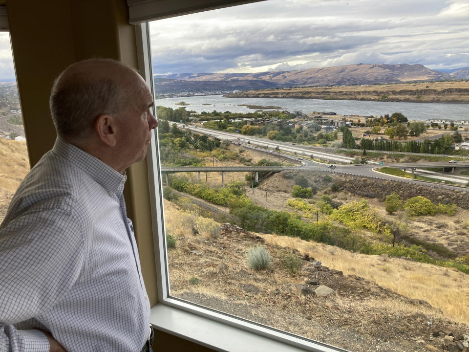 In this Tuesday, Oct. 5, 2021, photo, The Dalles Mayor Richard Mays looks at the view of his town and the Columbia River from his hilltop home in The Dalles, Oregon. Mays helped negotiate a proposal by Google to build new data centers in the town. The data centers require a lot of water to cool their servers, and would use groundwater and surface water, but not any water from the Columbia River. (AP Photo/Andrew Selsky)