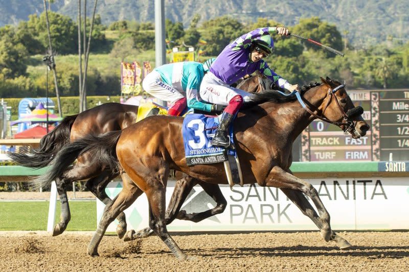 Jockey Antonio Fresu celebrates as Stronghold wins the Santa Anita Derby. Benoit Photography, courtesy of Santa Anita