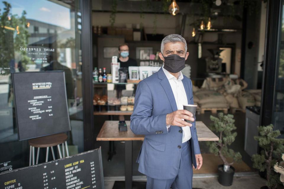 Wake-up call: Sadiq Khan grabs a coffee at a cafe in Queen Elizabeth Olympic Park (PA)