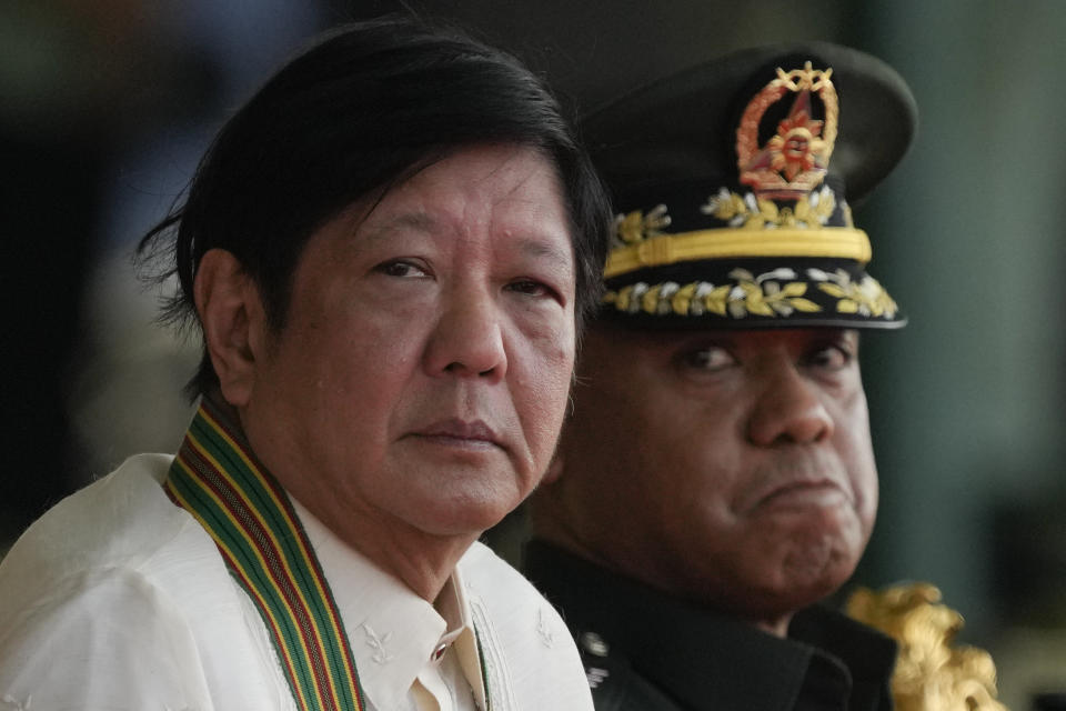 Philippine President Ferdinand Marcos Jr., left, sits beside Philippine Army Commanding General Lt. Gen. Romeo Brawner Jr. during the 126th founding anniversary of the Philippine Army at Fort Bonifacio in Taguig, Philippines on Wednesday, March 22, 2023. (AP Photo/Aaron Favila)