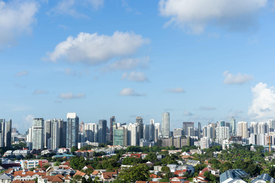 Singapore city skyline with clear sky and clouds