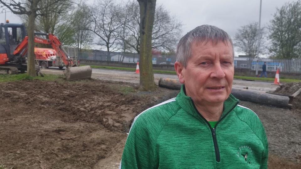 Noel McMonagle standing beside the burst water main which caused the flood damage