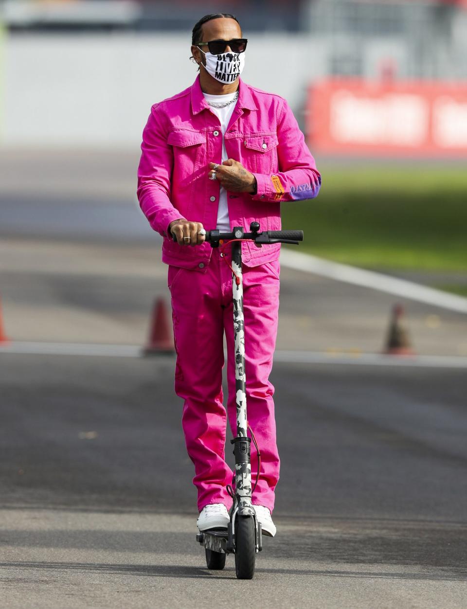 <p>Lewis Hamilton rides a scooter during the 2020 Formula One Emilia Romagna Grand Prix on Friday in Imola, Italy.</p>