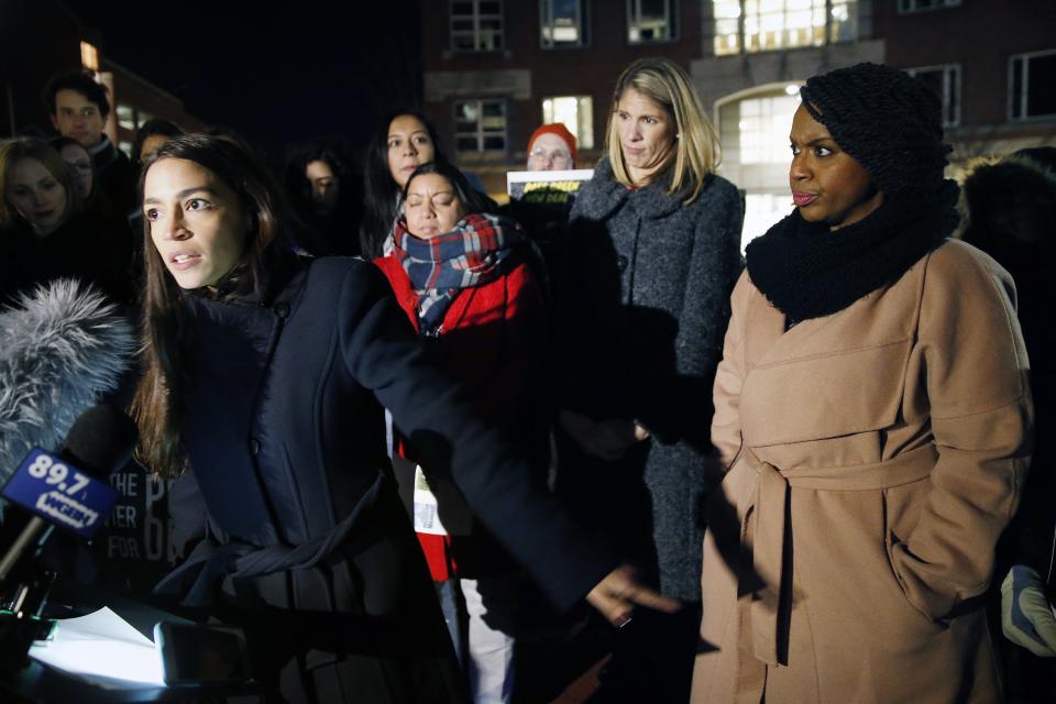 Rep.-elect Alexandria Ocasio-Cortez, D-N.Y.,, left, speaks at a small rally outside an orientation meeting for incoming members of Congress at Harvard University as Rep.-elect Ayanna Pressley, D-Mass., right, and Rep.-elect Lori Trahan, D-Mass., second from right, look on in Cambridge, Mass., Tuesday, Dec. 4, 2018. (AP Photo/Michael Dwyer)