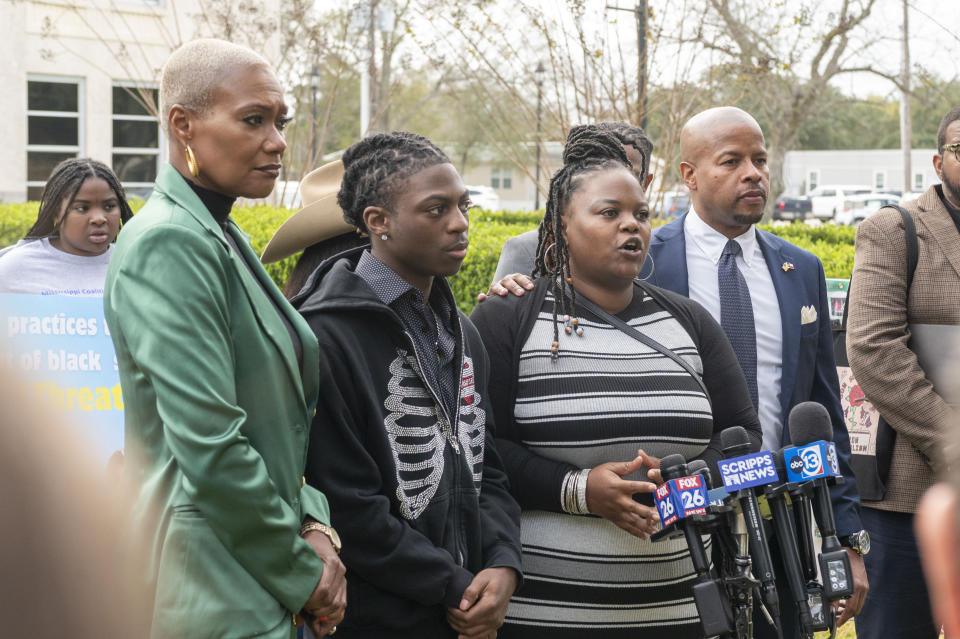 State representative Jolanda Jones, left, Darryl George, left center, and state representative Ron Reynolds, right, listen as Darresha George comments during a press conference before a hearing regarding George's punishment for violating school dress code policy because of his hair style, Thursday Feb. 22, 2024 at the Chambers County Courthouse in Anahuac, Texas. A judge has ruled that George's monthslong punishment by his Texas school district for refusing to change his hairstyle does not violate a new state law prohibiting race-based hair discrimination. (Kirk Sides/Houston Chronicle via AP)