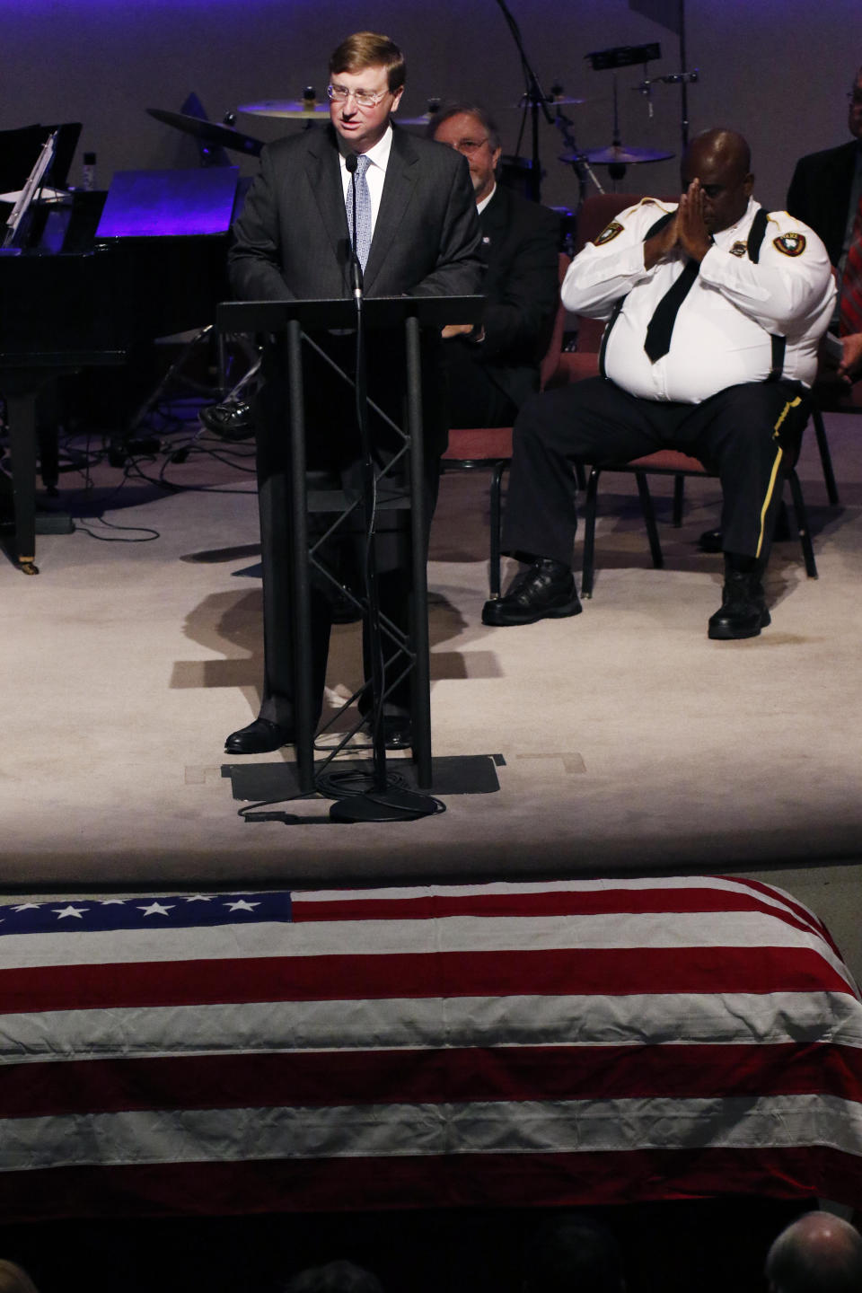 Lt. Gov. Tate Reeves, speaking on behalf of Gov. Phil Bryant and the state of Mississippi, extends his condolences to the family during funeral services Thursday, Oct. 4, 2018, for Brookhaven Police Corporal Zach Moak at Easthaven Baptist Church in Brookhaven, Miss. Moak and officer James White were killed early Saturday, Sept. 30, responding to a call. (AP Photo/Rogelio V. Solis)