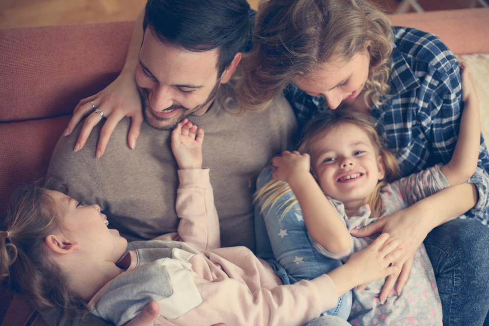 Happy family at home spending time together. From above.